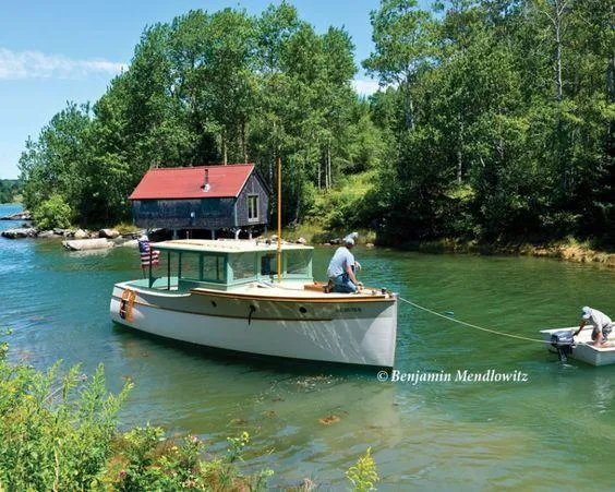 Slide: The Image of Classic 1929 Lobster Cruiser on a serene lake near a rustic cabin. - 6