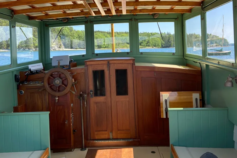 Slide: The Image of Interior of a 1929 Classic Lobster Cruiser with wooden helm and scenic windows. - 8