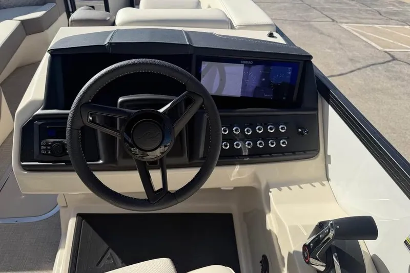 Slide: The Image of 2026 Alera M 25Q boat dashboard with steering wheel and control panel. - 12
