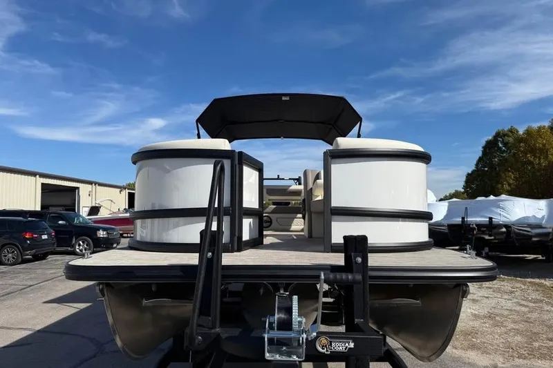Slide: The Image of 2026 Alera M 25Q pontoon boat on trailer under clear blue sky. - 2