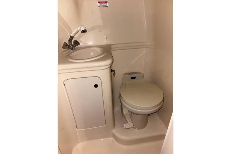 Slide: The Image of Compact bathroom in 2002 Sea Ray 260 Sundancer boat with sink and toilet. - 11