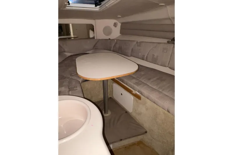 Slide: The Image of Interior of 2002 Sea Ray 260 Sundancer with seating and table setup. - 15