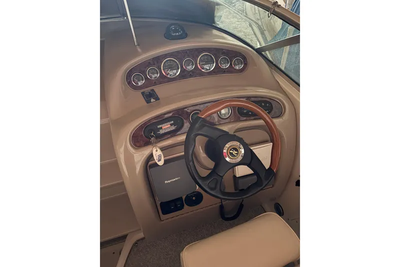Slide: The Image of Steering console of 2002 Sea Ray 260 Sundancer with gauges and wood-trimmed wheel. - 20