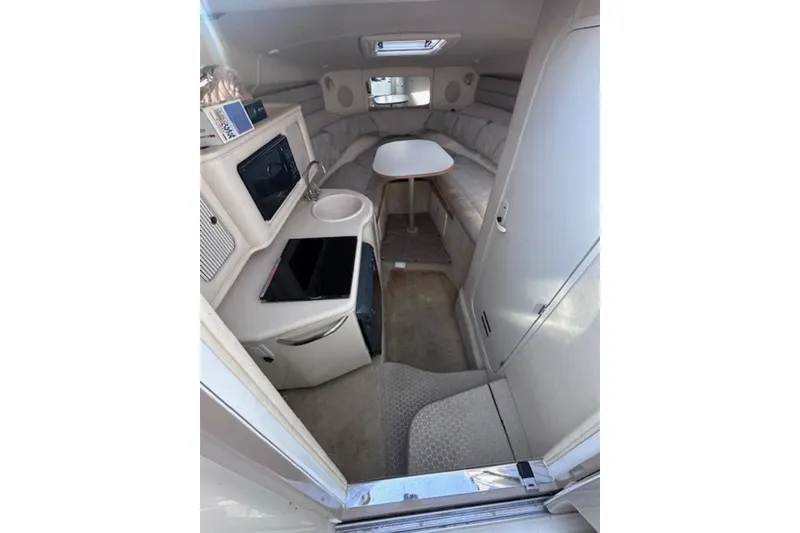 Slide: The Image of Interior of 2002 Sea Ray 260 Sundancer boat with kitchenette and seating area. - 21