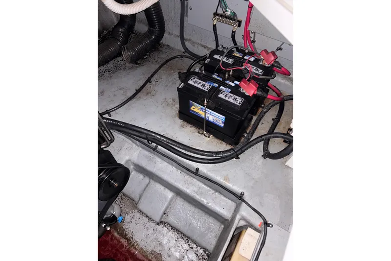 Slide: The Image of Battery compartment of a 2002 Sea Ray 260 Sundancer boat, showing wiring and connections. - 23