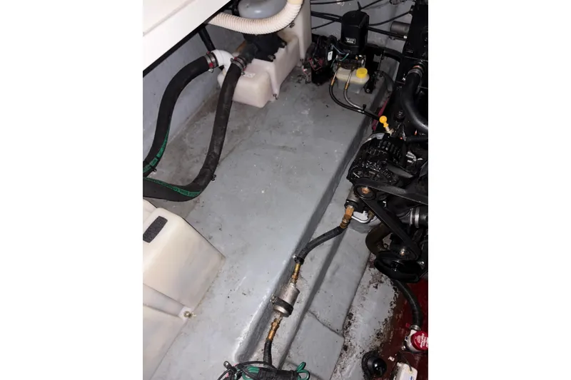 Slide: The Image of Engine compartment of a 2002 Sea Ray 260 Sundancer boat, showing hoses and components. - 24