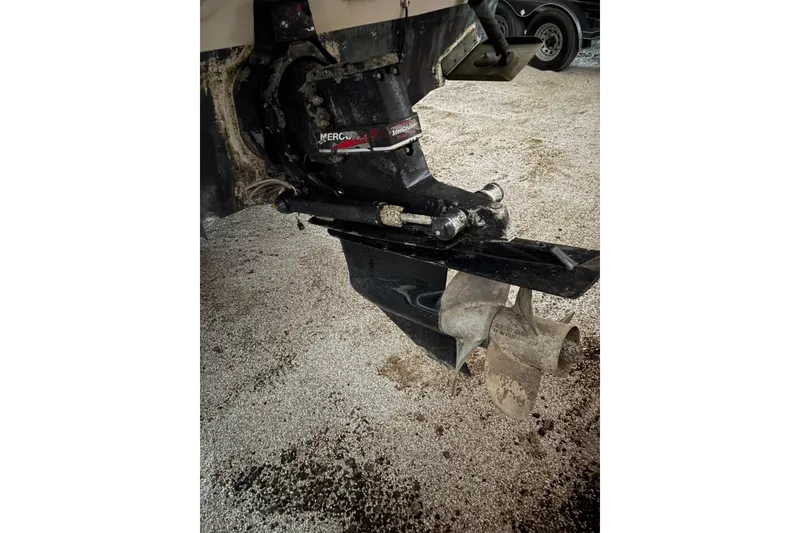Slide: The Image of Outboard motor of 2002 Sea Ray 260 Sundancer on gravel surface. - 26