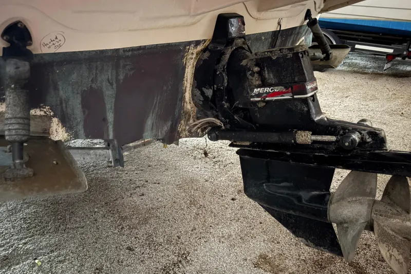 Slide: The Image of 2002 Sea Ray 260 Sundancer boat stern drive with visible wear and marine growth. - 27