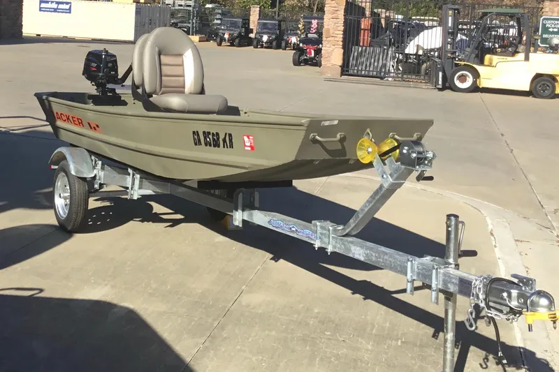 Slide: The Image of 2024 Tracker Grizzly 1236 Jon boat on trailer, parked outdoors. - 2