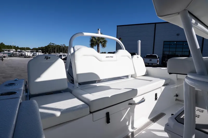 Slide: The Image of 2026 Sea Pro 225FLX Sandbar boat interior with white seating and storage compartments. - 10