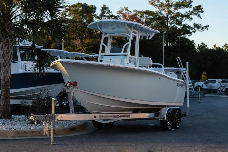 Slide: The Image of 2026 Sea Pro 225FLX Sandbar boat on trailer, parked outdoors. - 3