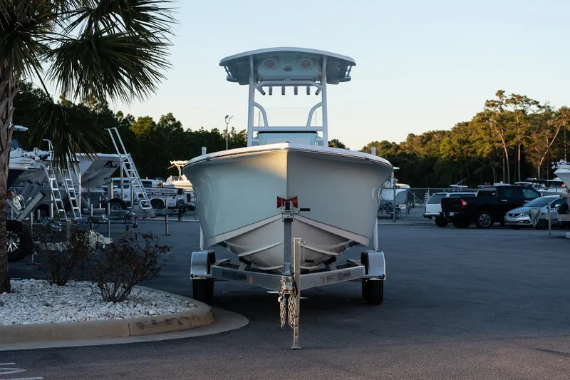 Slide: The Image of 2026 Sea Pro 225FLX Sandbar boat on trailer in parking lot, surrounded by trees. - 4