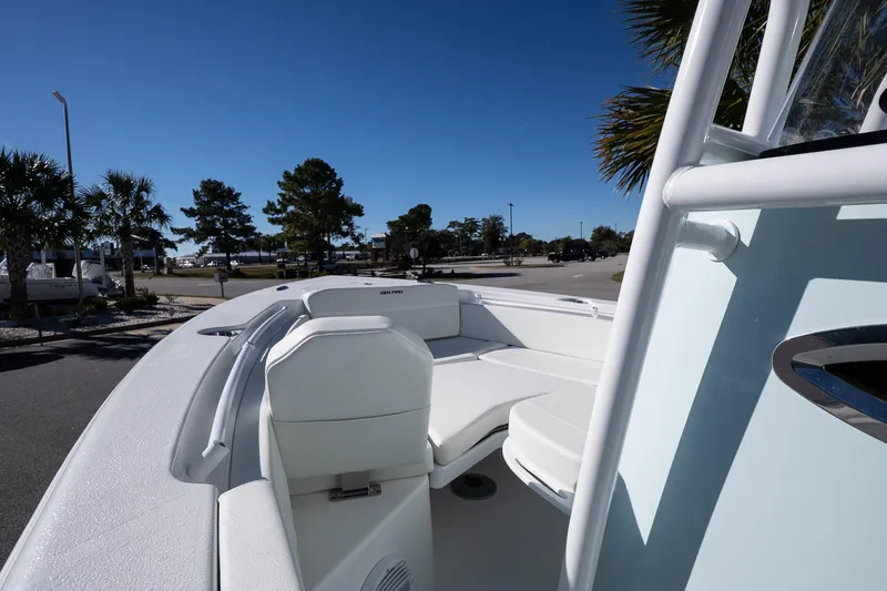 Slide: The Image of 2026 Sea Pro 225FLX Sandbar boat with white seating, parked outdoors under clear blue sky. - 16