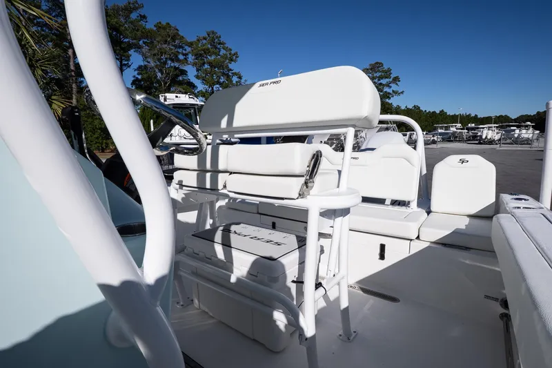 Slide: The Image of 2026 Sea Pro 225FLX Sandbar boat interior with white seating and storage compartments. - 19
