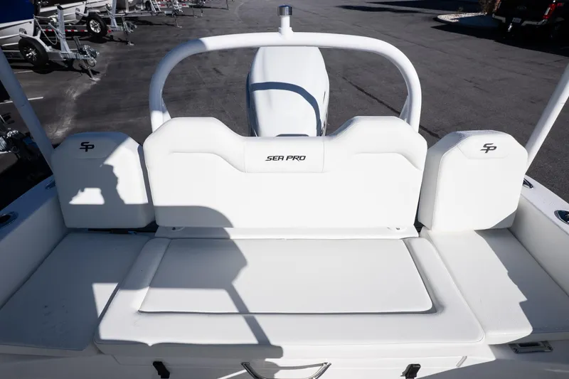 Slide: The Image of 2026 Sea Pro 225FLX Sandbar boat interior with white seating and logo details. - 9