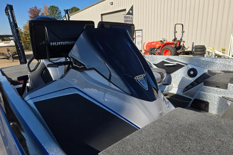 Slide: The Image of 2025 Skeeter FXR20 PRO boat with Humminbird electronics, parked near service area. - 3