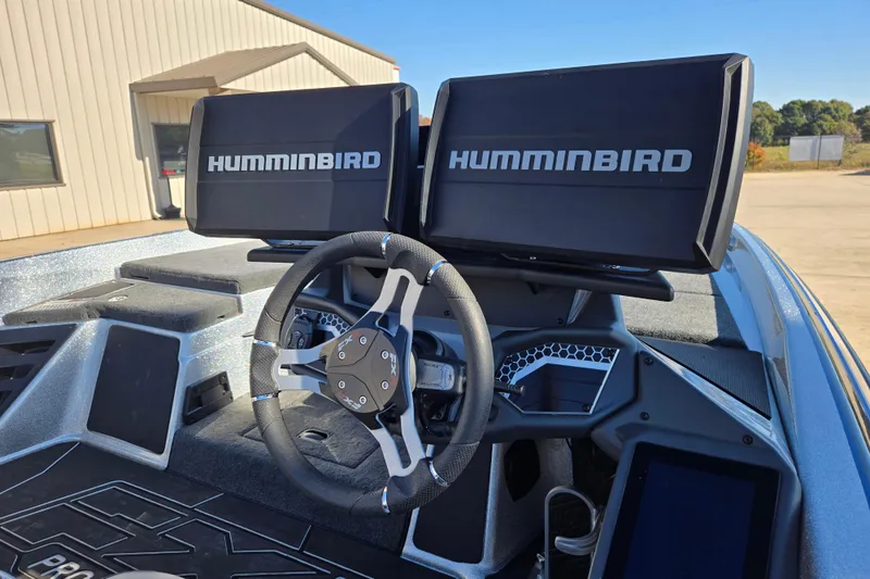 Slide: The Image of 2025 Skeeter FXR20 PRO boat dashboard with dual Humminbird displays and steering wheel. - 4