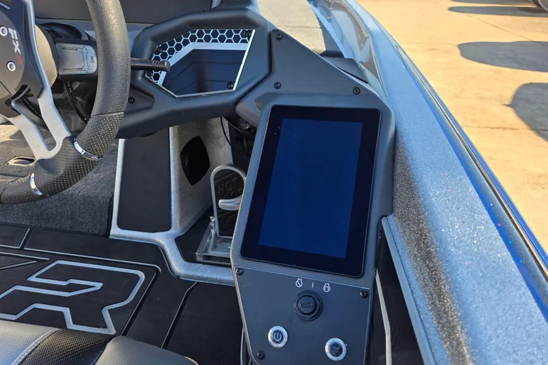 Slide: The Image of 2025 Skeeter FXR20 PRO boat dashboard with steering wheel and touchscreen display. - 7