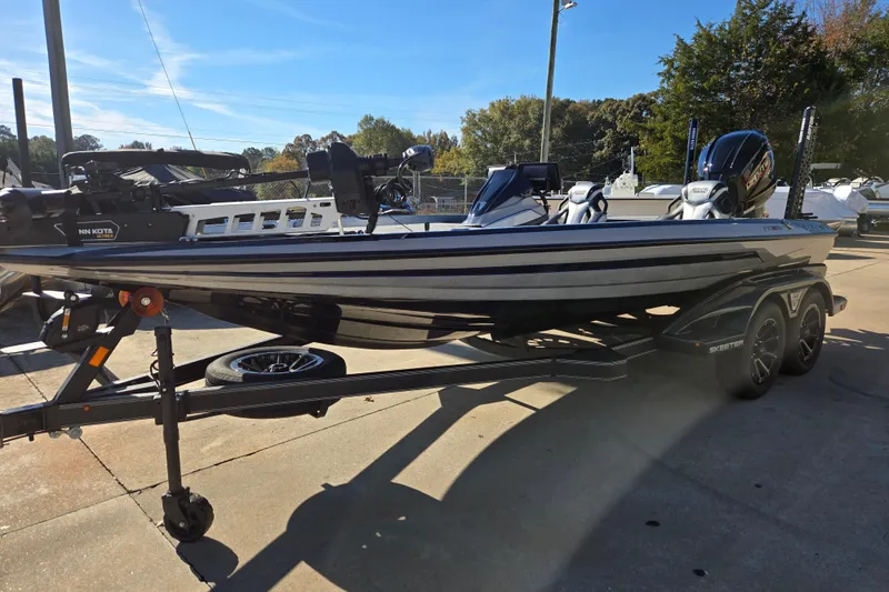 Slide: The Image of 2025 Skeeter FXR20 PRO boat on trailer, parked outdoors under clear sky. - 9
