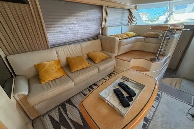 Slide: The Image of Luxurious interior of a 2004 Sea Ray 420 Sedan Bridge yacht with beige seating and yellow cushions. - 13