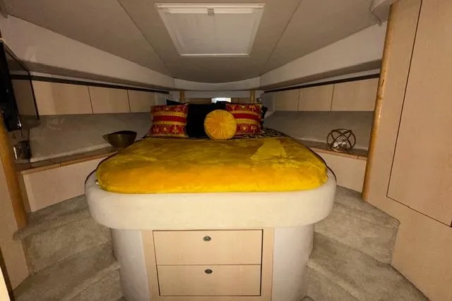 Slide: The Image of Luxurious cabin interior of 2004 Sea Ray 420 Sedan Bridge yacht with vibrant bedding. - 16