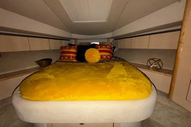 Slide: The Image of Luxurious cabin interior of 2004 Sea Ray 420 Sedan Bridge with vibrant bedding. - 17