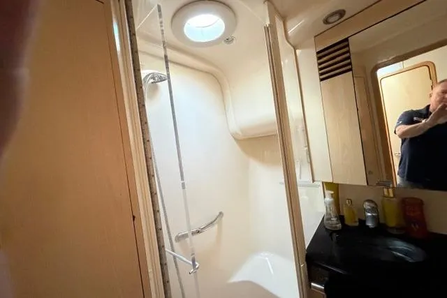 Slide: The Image of Bathroom interior of 2004 Sea Ray 420 Sedan Bridge yacht, featuring shower and vanity. - 19