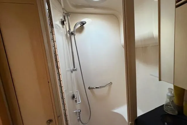 Slide: The Image of 2004 Sea Ray 420 Sedan Bridge shower area with modern fixtures and sleek design. - 20