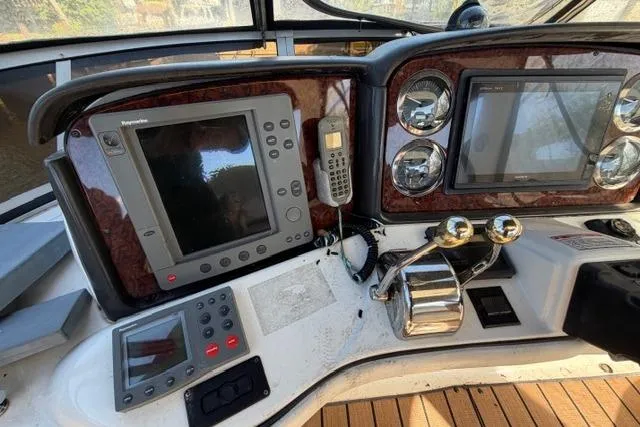 Slide: The Image of 2004 Sea Ray 420 Sedan Bridge helm with navigation equipment and controls. - 6