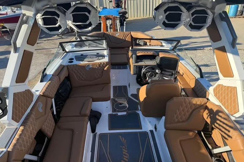 Slide: The Image of 2026 Tigé 22RZX boat interior with brown leather seating and advanced audio system. - 10