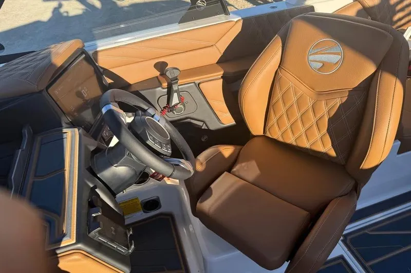 Slide: The Image of 2026 Tigé 22RZX boat interior with luxurious brown leather seating and modern steering console. - 11