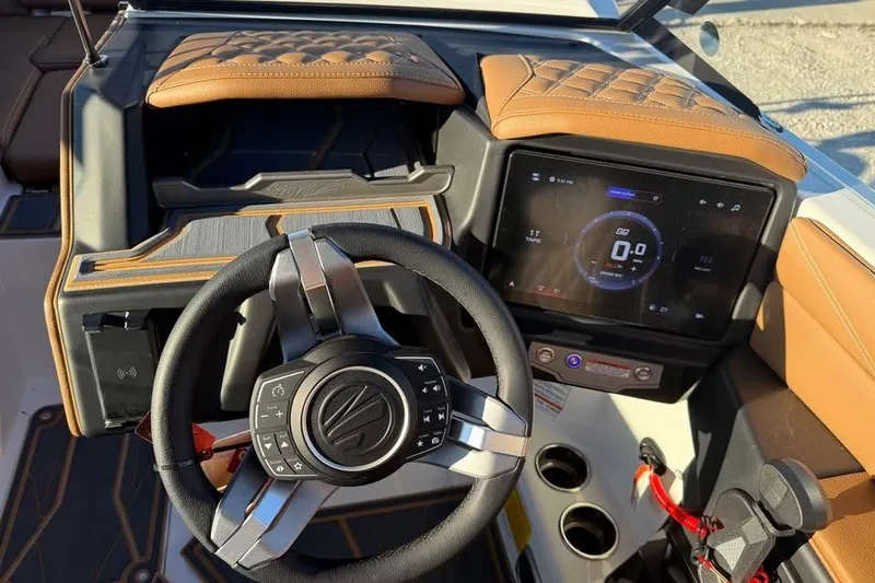 Slide: The Image of 2026 Tigé 22RZX boat dashboard with modern steering wheel and digital display. - 12