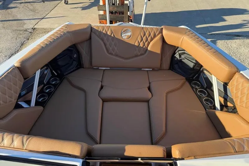 Slide: The Image of 2026 Tigé 22RZX boat interior with brown leather seating and cup holders. - 14