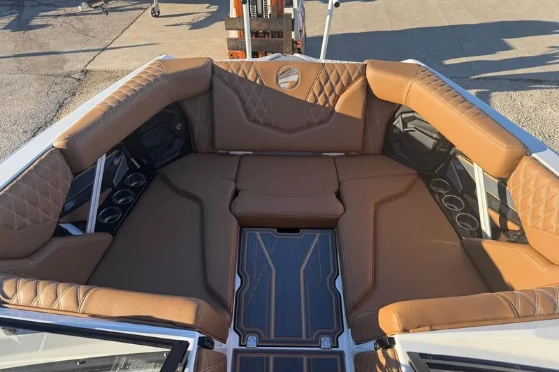 Slide: The Image of Luxurious interior of 2026 Tigé 22RZX boat with brown leather seating and cup holders. - 15