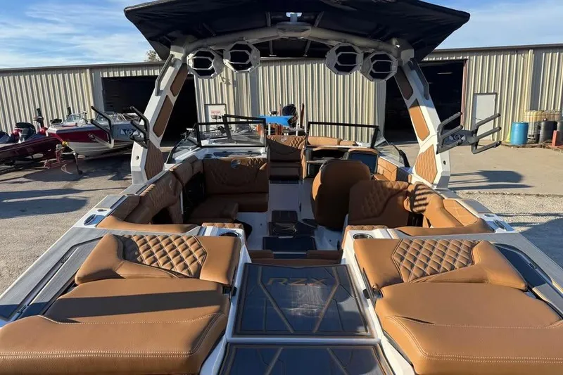 Slide: The Image of 2026 Tigé 22RZX boat interior with luxurious brown seating and modern design. - 8