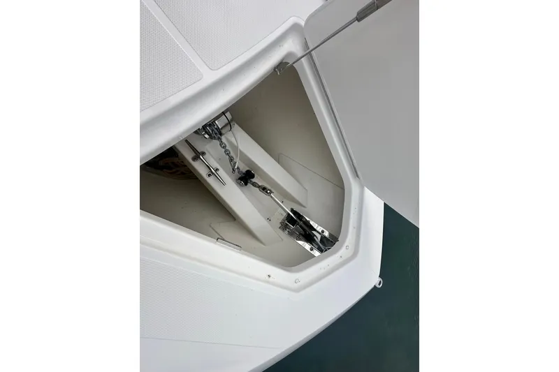 Slide: The Image of Anchor compartment of 2023 Tiara Yachts 34 LS, showcasing chain and mechanism. - 17
