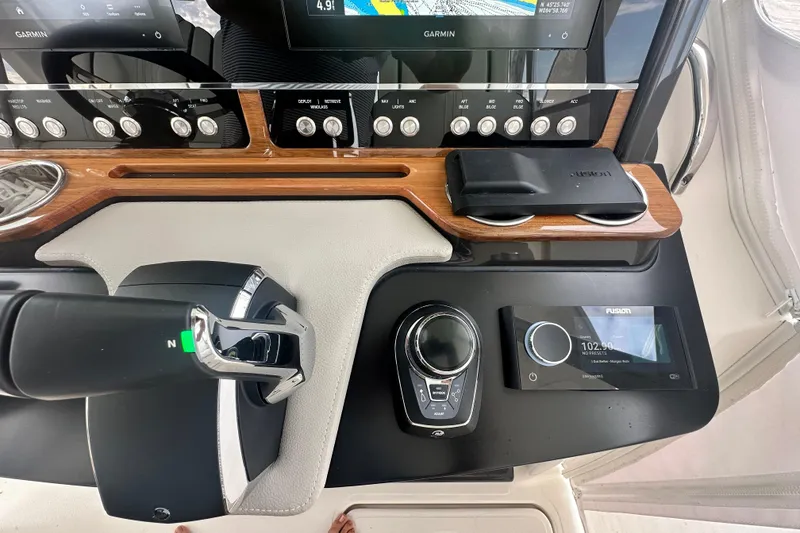 Slide: The Image of 2023 Tiara Yachts 34 LS dashboard with Garmin navigation and Fusion audio controls. - 20