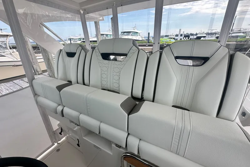 Slide: The Image of 2023 Tiara Yachts 34 LS interior seating with luxurious white upholstery. - 23