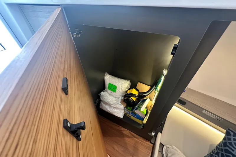 Slide: The Image of Open cabinet on 2023 Tiara Yachts 34 LS, showing storage items inside. - 27