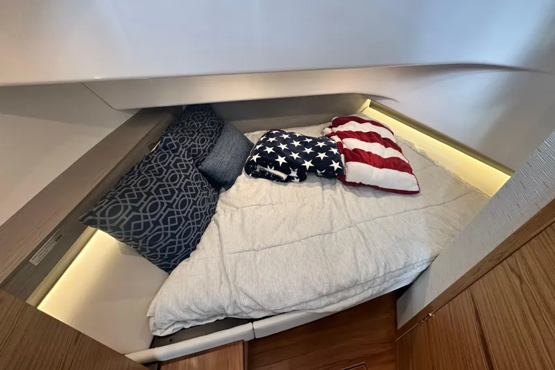 Slide: The Image of Cozy cabin interior of 2023 Tiara Yachts 34 LS with stylish bedding and pillows. - 28