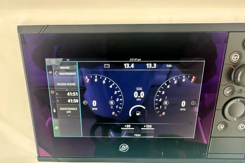 Slide: The Image of 2023 Tiara Yachts 34 LS dashboard display showing engine hours and RPM gauges. - 30
