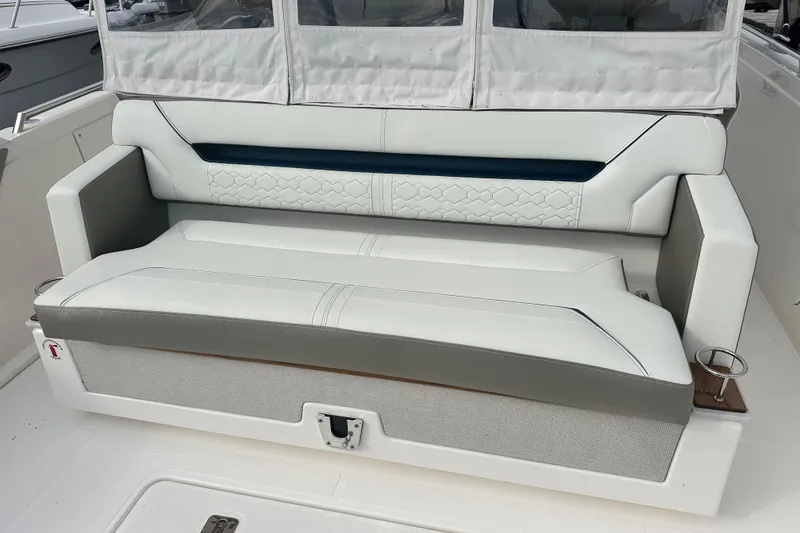 Slide: The Image of 2023 Tiara Yachts 34 LS boat seating, featuring elegant white and gray upholstery. - 6