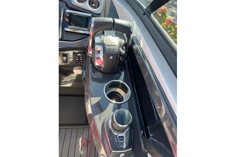 Slide: The Image of 2017 Monterey 328SS Super Sport boat dashboard with controls and cup holders. - 12