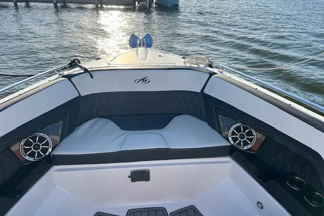 Slide: The Image of 2017 Monterey 328SS Super Sport boat interior with cushioned seating and speakers on a sunny day. - 14