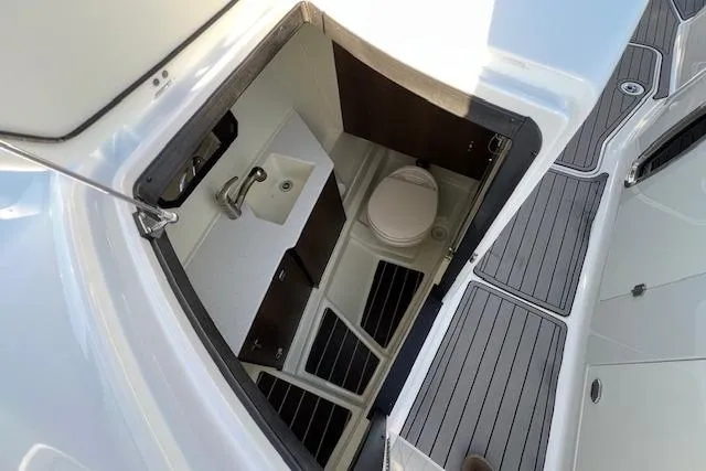 Slide: The Image of 2017 Monterey 328SS Super Sport boat interior with compact bathroom and sink. - 16