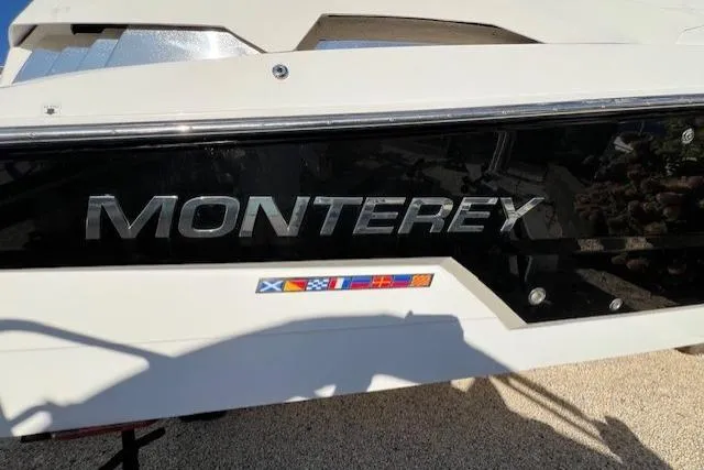 Slide: The Image of 2017 Monterey 328SS Super Sport boat with logo and nautical flags. - 4