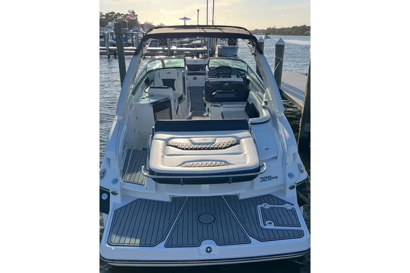 Slide: The Image of 2017 Monterey 328SS Super Sport boat docked, showcasing sleek design and spacious seating. - 5