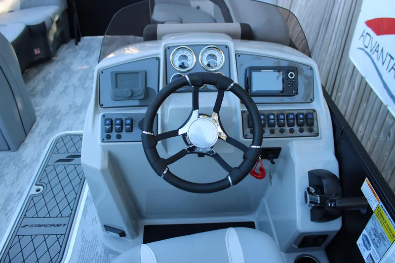 Slide: The Image of 2026 Starcraft EXS 3 boat dashboard with steering wheel and control panel. - 11