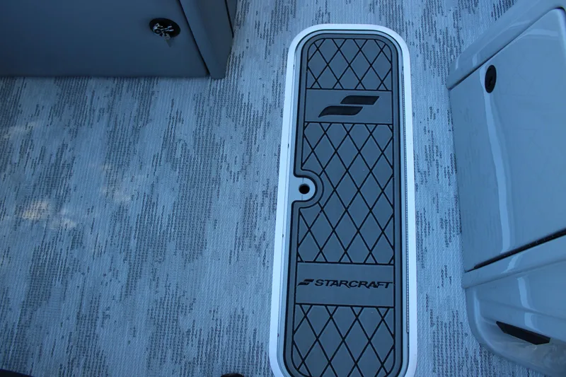 Slide: The Image of 2026 Starcraft EXS 3 boat deck with logo and textured flooring. - 23