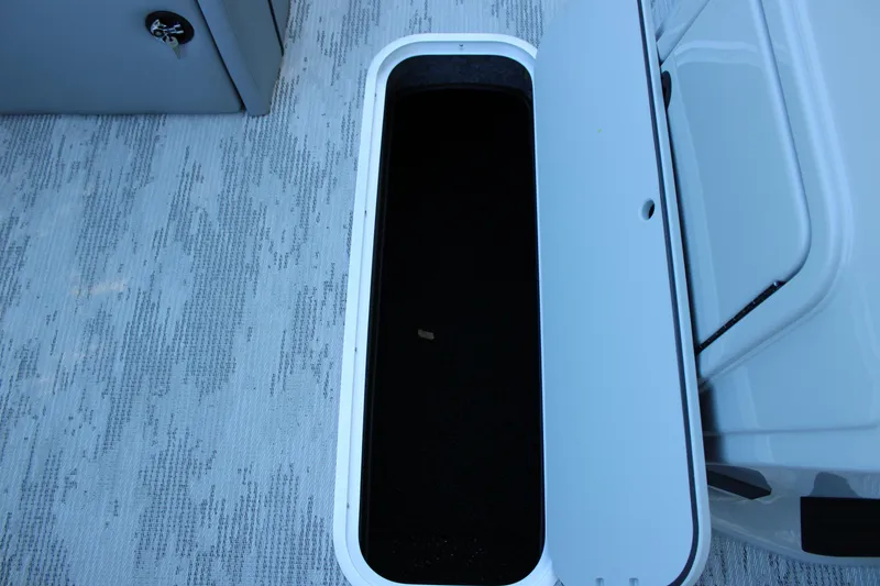 Slide: The Image of Open storage compartment on 2026 Starcraft EXS 3 boat, featuring sleek design and spacious interior. - 24